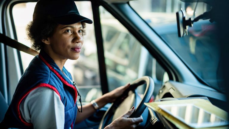 Close up female fleet driver behind the wheel of a truck | Fleet Maintenance | Visual Planning