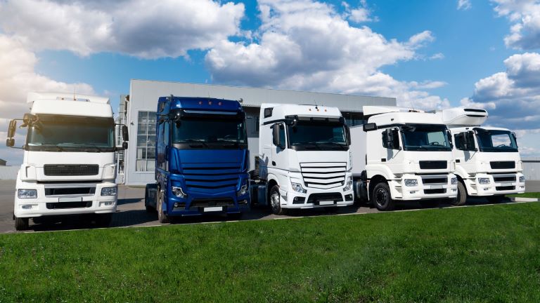 Blue and white trucks lined up in big lot | Fleet Maintenance | Visual Planning