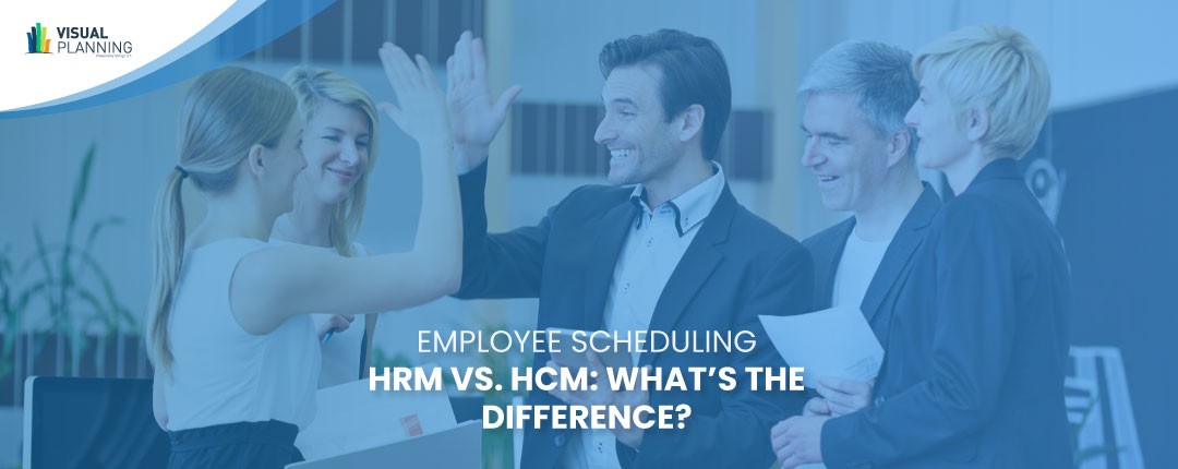 Team of talent management professionals high-fiving during a meeting | HRM vs. HCM
