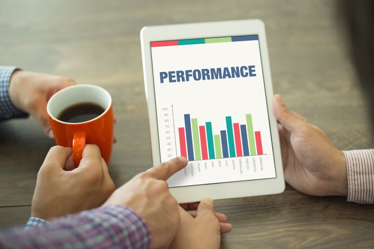 Managers looking over employees’ performance metrics | Improve operational efficiency