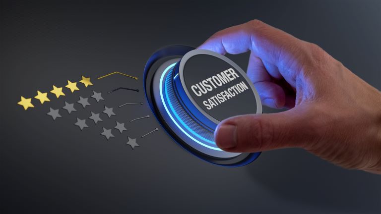 Hand turning a knob with the text, “Customer Satisfaction,” on it | Improve customer satisfaction