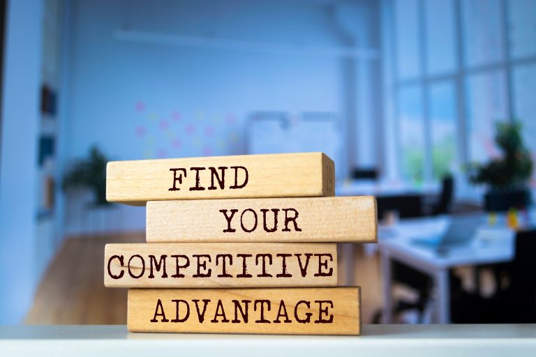 Wooden blocks that spell the words, “Find Your Competitive Advantage” | Improve customer satisfaction